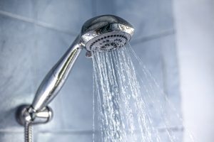 Soft water coming out of a silver showerhead.