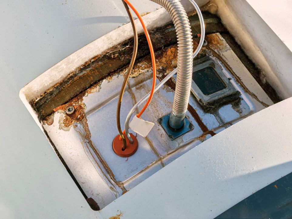 An old, rusty water heater panel
