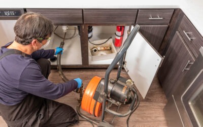 plumber using a drain snake