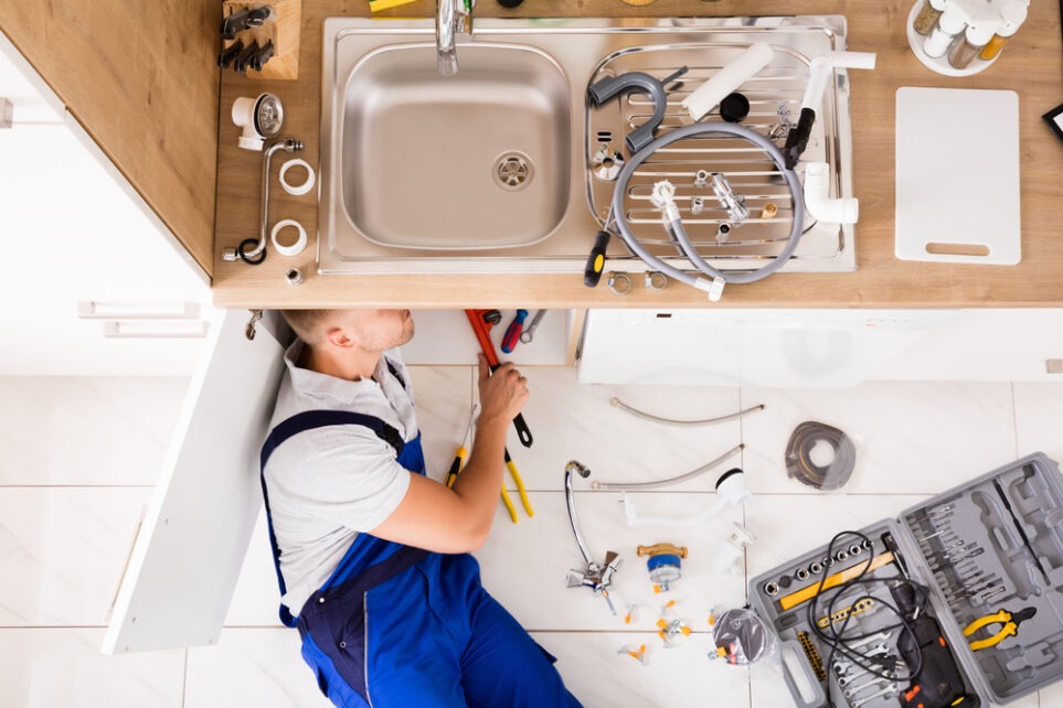 plumber working on a sink