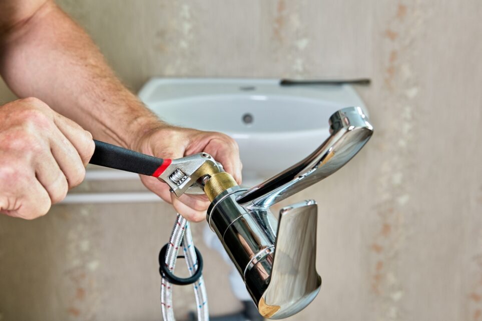 A plumber in Arizona working on pipes.